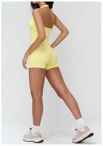 Detail view of pale yellow V-neck halter yoga top and high waist shorts set