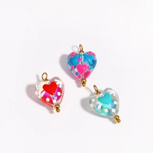 Three colorful heart-shaped glass pendants with gold loops for DIY jewelry making