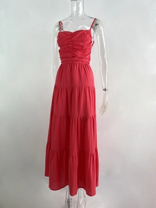 Detail of red tiered cake dress featuring a pleated bodice and thin shoulder straps