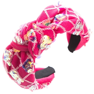 Detail of a pink knotted headband with iridescent sequins and white mesh fabric overlay