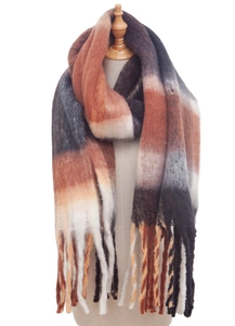 Detail of soft loop yarn scarf featuring orange and grey gradient stripes and fringe