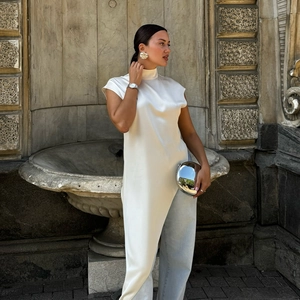 Elegant white mock neck satin sleeveless top featuring a sleek draped bias-cut silhouette