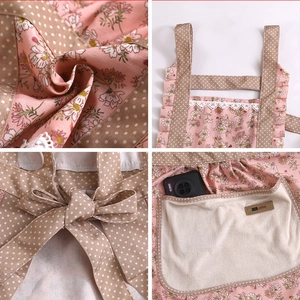 Detailed view of women's floral apron, featuring polka dot straps, lace trim, and convenient pocket.