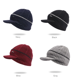 Close-up of cable knit textures and metal logo tags on winter peaked beanies in four colors