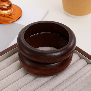 Minimalist sandalwood bangles set in deep brown, featuring natural wood grain finish