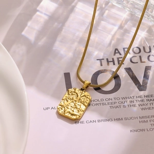 Detailed macro view of 18k gold plated snake chain with a rectangular lava pendant