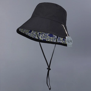 Waterproof nylon bucket hat for women with reversible abstract graffiti interior and cord
