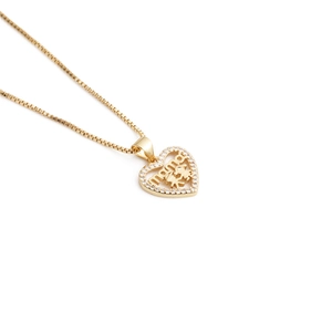 Detail of gold heart pendant with zircon border and mama lettering for mothers