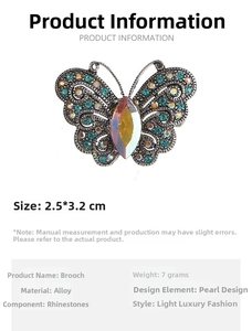Close-up of butterfly brooch with teal and iridescent rhinestones showing 2.5x3.2cm size