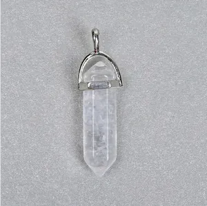 Macro shot of a hexagonal natural clear quartz crystal pendant with a silver metal clasp