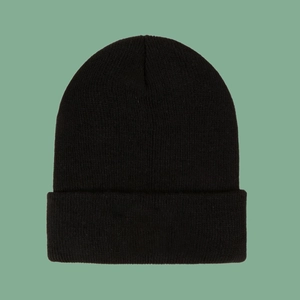 Close-up of black knit beanie featuring thick ribbed texture and trendy rolled cuff detail