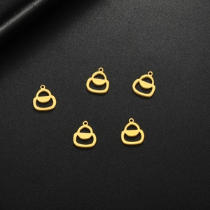 Close-up of five golden stainless steel handbag shaped pendants on black leather
