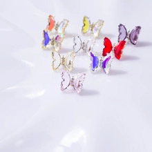 Detailed macro view of colorful resin butterfly charms for DIY 3D nail art decorations