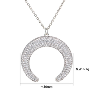Crescent moon pendant necklace with pavé zircon stones in polished silver finish