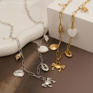 Ocean themed necklace with crab seashell charms and gold silver finish on metal chain