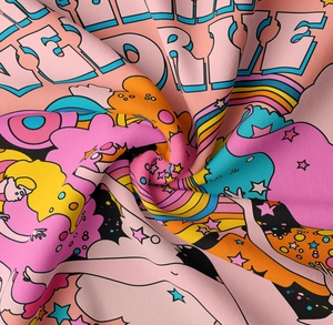 Close-up of pop art tapestry fabric texture with love drive typography and stars