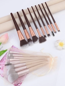 Flat lay of 9-piece makeup brush set with mesh pouch and synthetic bristles for face and eyes