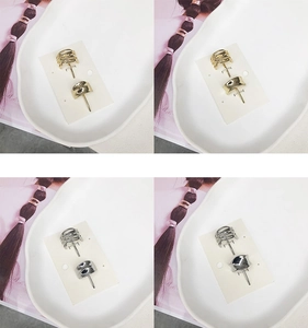 Detail of minimalist gold and silver alloy hair clips set on a decorative ceramic plate