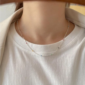 Minimalist 925 sterling silver necklace with colorful beads on a female model