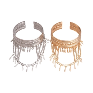 Bohemian gold and silver arm cuffs with geometric engraving and leaf fringe tassels