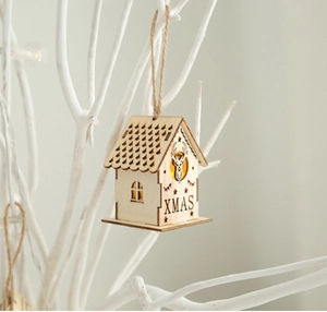 Close-up of LED wooden Christmas house pendant with XMAS engraving and reindeer pattern