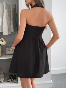 Detail view of the elegant halter backless design with hidden zipper on the black dress