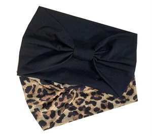 Detail shot of black bow and leopard print wide headbands in elastic knit fabric