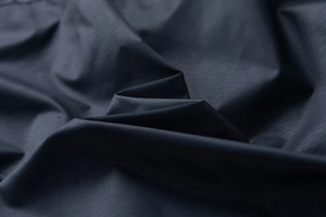 Macro shot of breathable ripstop fabric texture for men's summer casual jacket