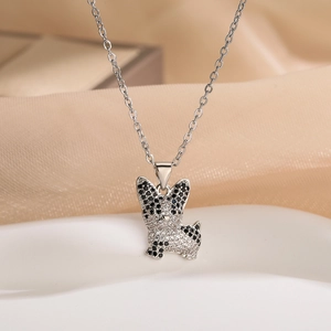 Silver bulldog pendant necklace with sparkling zircons on a soft silk background