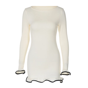 Detail of white long sleeve dress featuring contrasting black ruffled edges and hems
