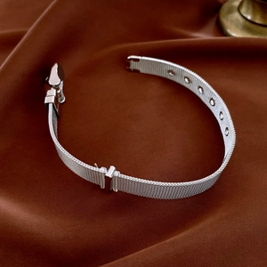 Detail of silver Milanese mesh bracelet with adjustable holes and premium metal buckle