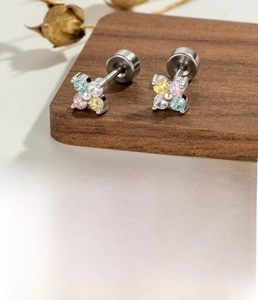Detailed view of silver flower cartilage stud earrings with colorful zirconia inlays