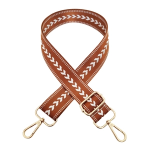 Adjustable brown nylon shoulder strap with white arrow pattern and gold metal hardware