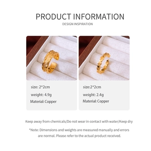 Detail view of 24k gold plated copper rings with hammered texture and heart patterns