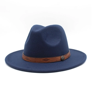 Detailed close-up of dark blue wool fedora featuring a patterned brown leather hatband