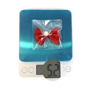 Detailed close-up showing a 5.2g lightweight red Christmas reindeer bow hair clip