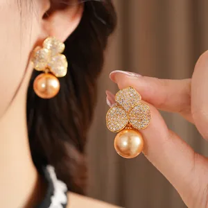Elegant gold plated flower leaf earrings with zircon pavé and golden pearl drop pendants