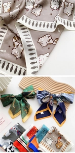 Close-up of silk scarf featuring elegant cat print and abstract pattern details