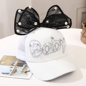 Detail of baby sun hat with black lace bow pearl accents and mesh back panel