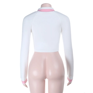 Detail of white cropped sweatshirt with pink ribbed neckline and cuffs on a mannequin