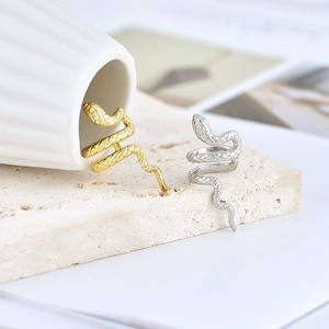 18k gold and silver plated snake ear cuffs with realistic scale textures on stone base