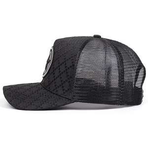 Detail of black jacquard mesh trucker hat with breathable honeycomb structure