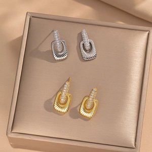 Vintage gold and silver square stud earrings with pavé crystals on a silk setting
