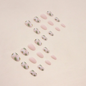 Pastel pink matte oval press-on nails with delicate white floral designs and solid tones