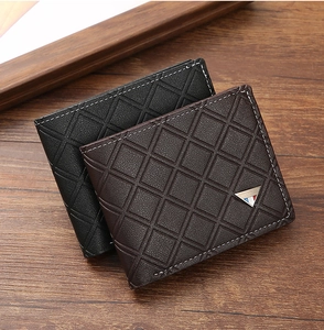Detail view of men's short leather wallets with geometric patterns and metal logo