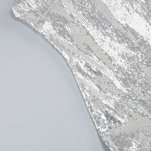 Detailed macro view of dense silver sequins and ruffles on a glamorous party dress