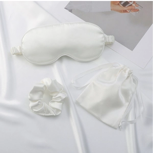 Three-piece white satin sleep set with silk eye mask, scrunchie, and drawstring pouch