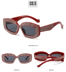 Detailed views of red rhinestone cat eye sunglasses from front and side angles