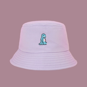 Close-up of purple canvas bucket hat featuring a detailed blue dinosaur embroidery