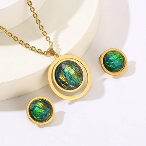 Detailed view of vintage gold heart earrings and necklace set with rainbow resin inlay